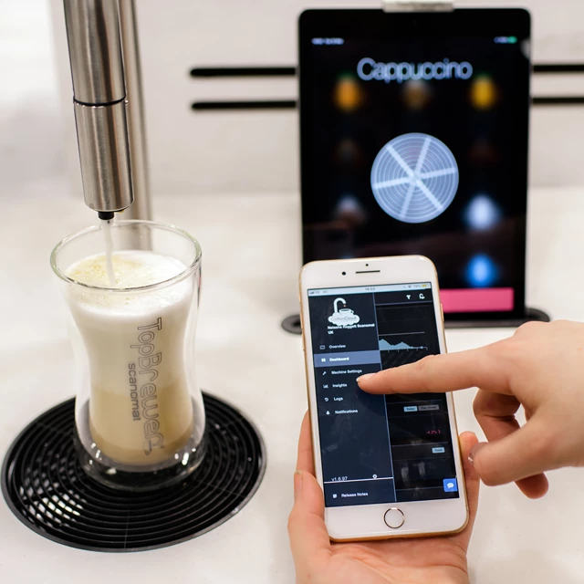 CoffeeCloud close up, showing menu on the app with TopBrewer in the background