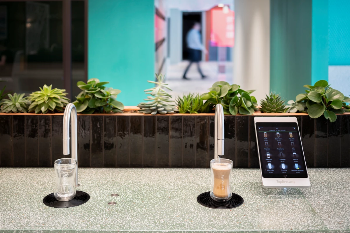 Image showing a TopBrewer commercial coffee machine on the right and a TopWater water dispenser on the left, both are built into the counter