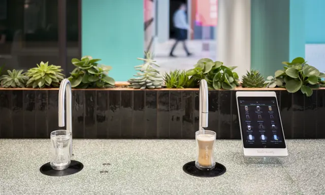 Image showing a TopBrewer commercial coffee machine on the right and a TopWater water dispenser on the left, both are built into the counter
