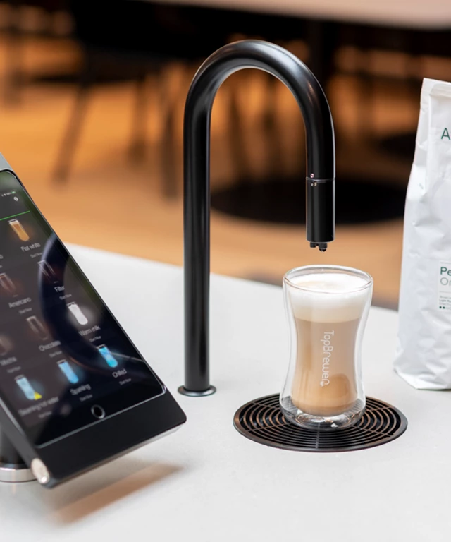 Image showing matte black TopBrewer with deluxe iPad holder and bag of Amokka coffee next to it