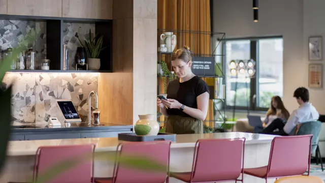 Wide shot in Uncle Southall showing a TopBrewer coffee machine and people in the background